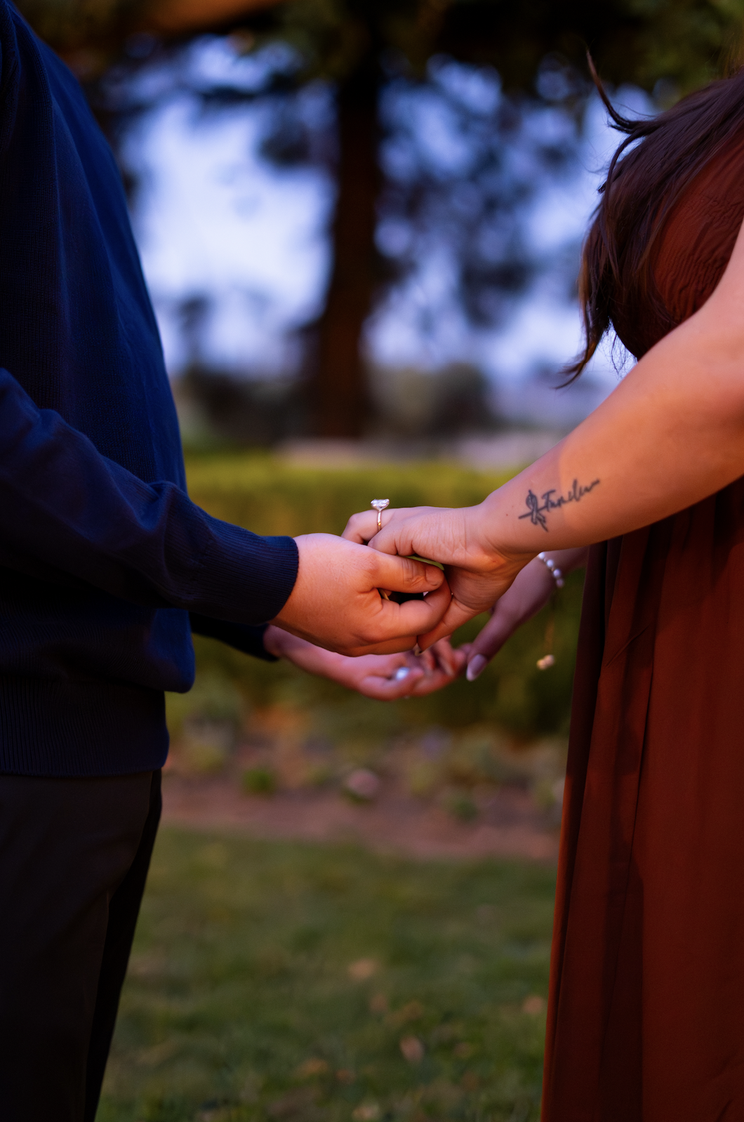 Nicholas holding Ashley's hand with the ring